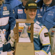 Team Doyle Racing drivers Wayne Taylor, Jim Pace and Scott Sharp hoist the winners trophy after capturing the 34th Rolex 24 at Daytona, 1996.